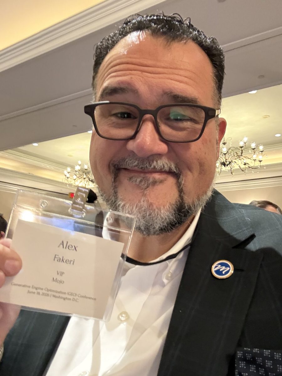 Alex Fakeri holding his GEO Conference 2026 badge at The Ritz-Carlton in Washington, D.C.